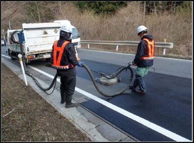 道路除染での側溝堆積物の除去作業の様子